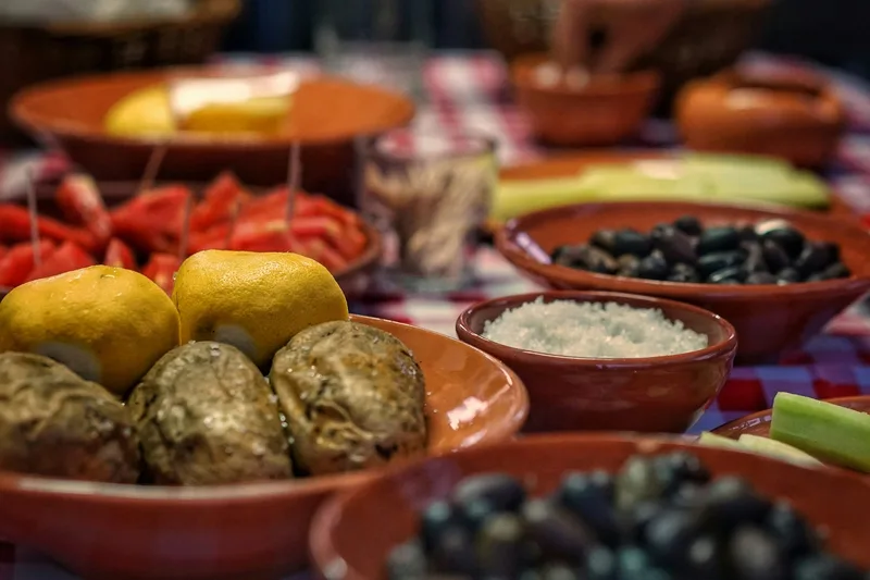 Market ingredients on earthenware provide a useful quieter counterpoint to the fire imagery