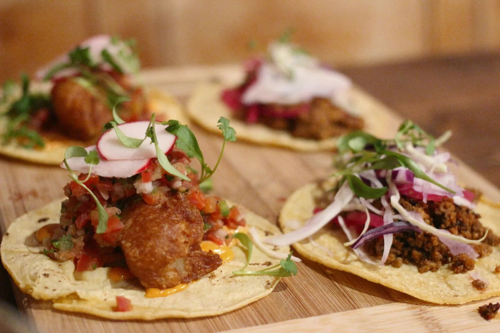 Strong landscape taco image with good warmth and variety across the fillings