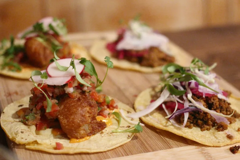 Strong landscape taco image with good warmth and variety across the fillings