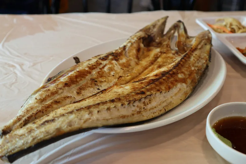 Simple grilled whole fish provides a quieter supporting menu image